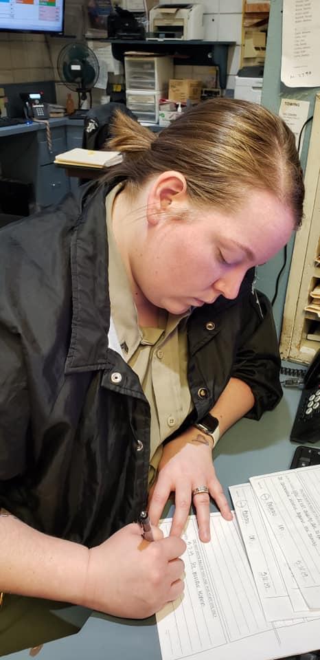 Corporal Heather Barroso answering inmate request forms