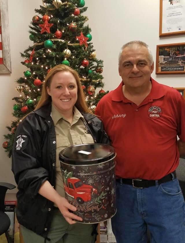 female deputy and citizen in front of a christmas tree